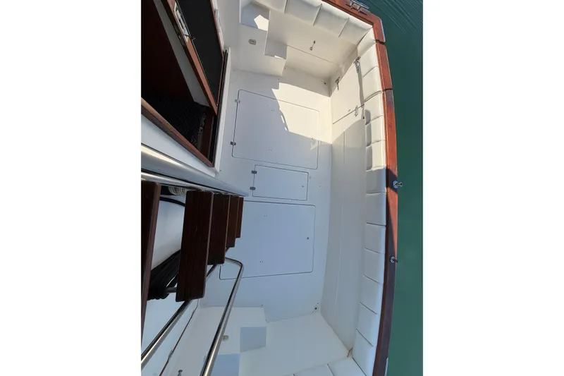 Slide: The Image of 1994 Bayliner 3888 MY Sedan boat deck with white seating and wooden accents. - 49