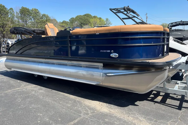 The Image of 2026 Harris Cruiser 230 SL pontoon boat with sleek design and tan seating. - 0