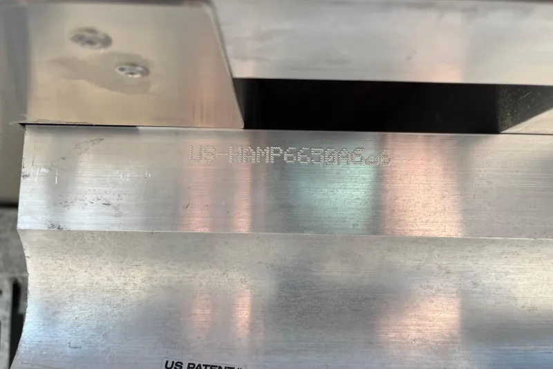 Slide: The Image of Close-up of metal surface with engraved text on a 2026 Harris Cruiser 230 SL. - 16