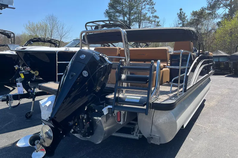 Slide: The Image of 2026 Harris Cruiser 230 SL pontoon boat with powerful outboard motor, parked outdoors. - 2