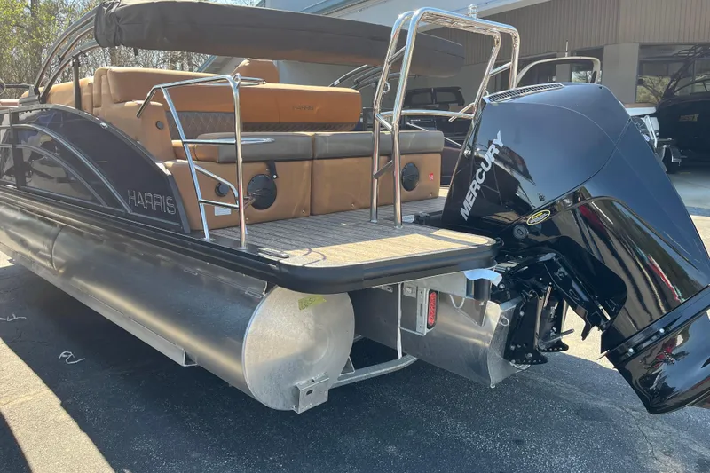 Slide: The Image of 2026 Harris Cruiser 230 SL pontoon boat with Mercury outboard motor, docked outdoors. - 3