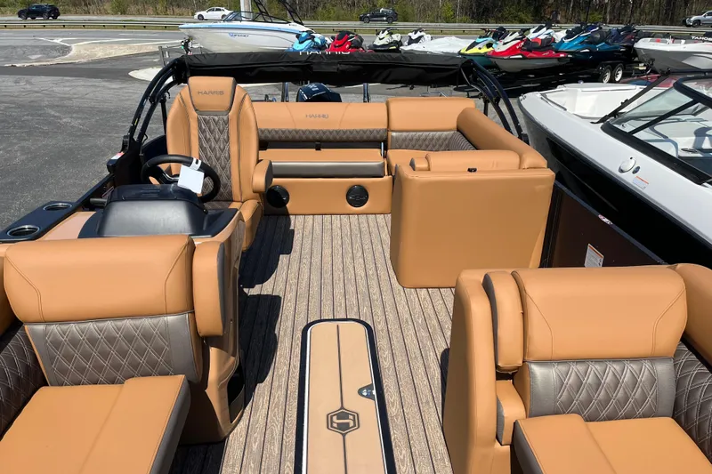 Slide: The Image of 2026 Harris Cruiser 230 SL pontoon boat with luxurious tan seating and sleek design. - 5