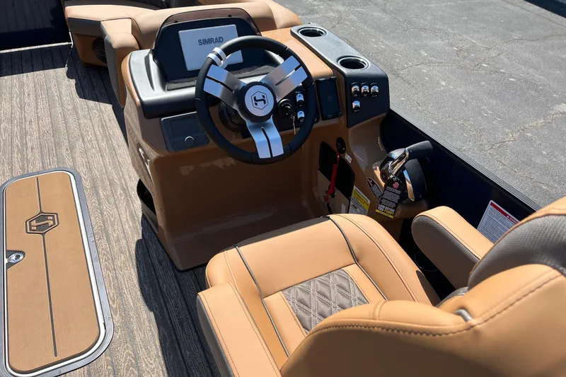 Slide: The Image of 2026 Harris Cruiser 230 SL boat interior with tan leather seating and modern steering console. - 6
