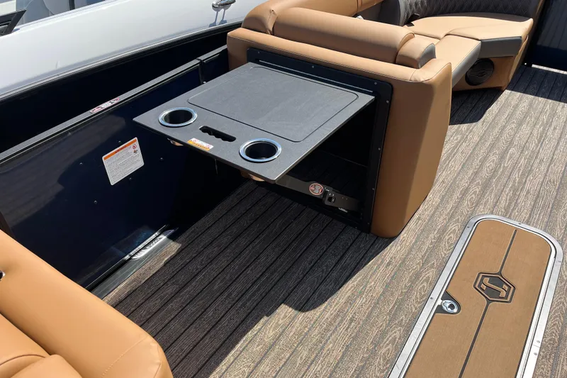 Slide: The Image of 2026 Harris Cruiser 230 SL interior with fold-out table and cup holders on deck. - 7