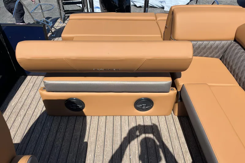 Slide: The Image of 2026 Harris Cruiser 230 SL boat interior with tan leather seating and textured flooring. - 8