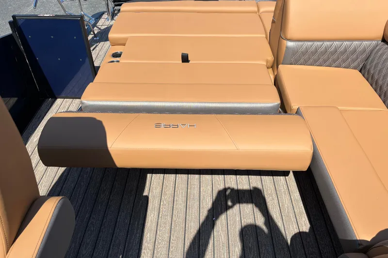 Slide: The Image of Luxurious seating on 2026 Harris Cruiser 230 SL boat with tan upholstery and sleek design. - 9