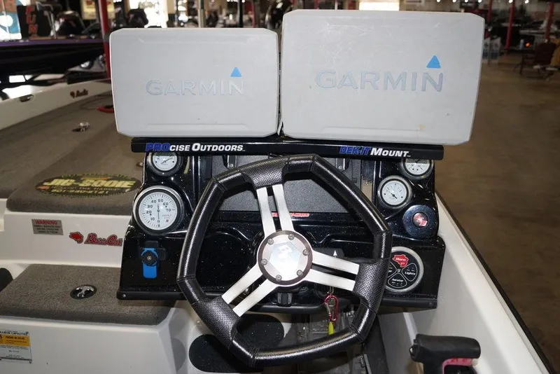 Slide: The Image of 2018 Bass Cat Pantera II boat dashboard with Garmin displays and steering wheel. - 13