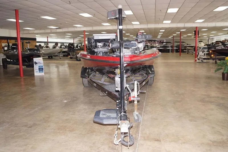 Slide: The Image of 2018 Bass Cat Pantera II boat displayed in a showroom with other boats. - 5