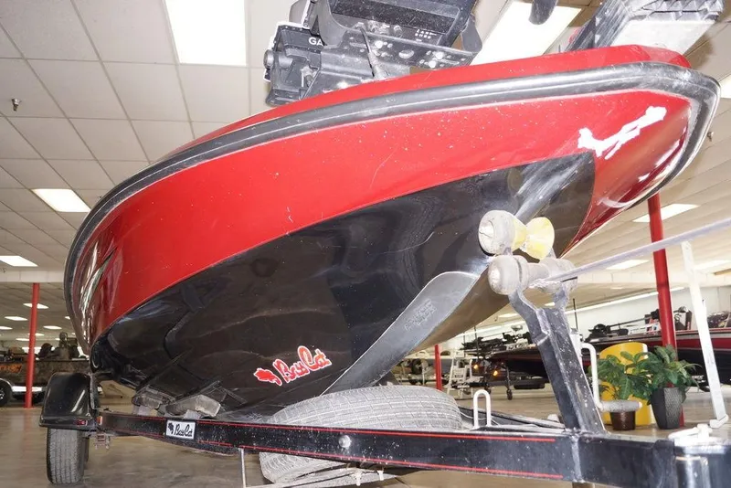 Slide: The Image of 2018 Bass Cat Pantera II boat in showroom, red and black hull on trailer. - 6