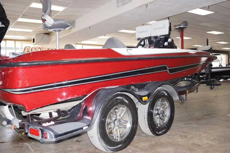 Slide: The Image of 2018 Bass Cat Pantera II boat in showroom, red with black accents, on a trailer. - 9