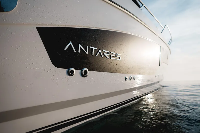Slide: The Image of 2025 Beneteau Antares 9 boat side view on water, sleek design. - 13