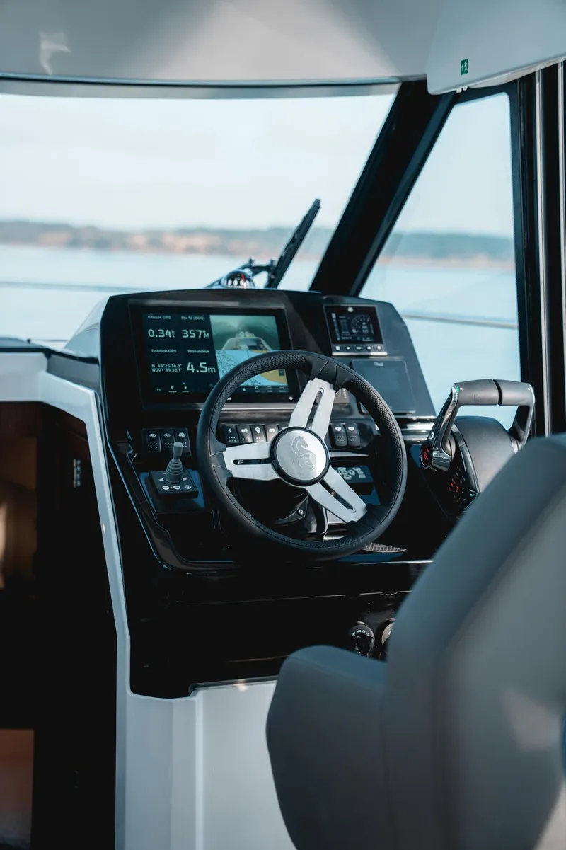Slide: The Image of 2025 Beneteau Antares 9 helm with modern controls and navigation display. - 19