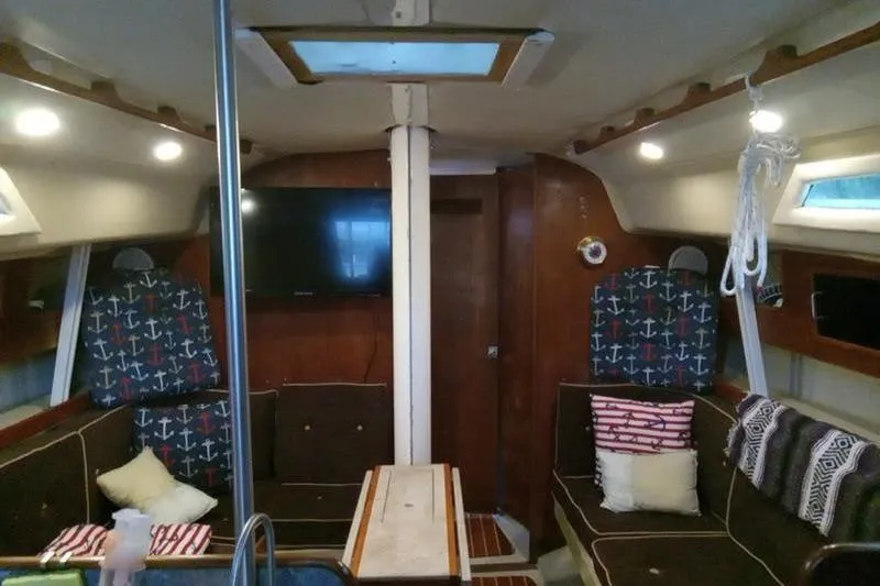 Slide: The Image of Interior of a 1979 C & C 36-1 sailboat with cozy seating and nautical decor. - 3