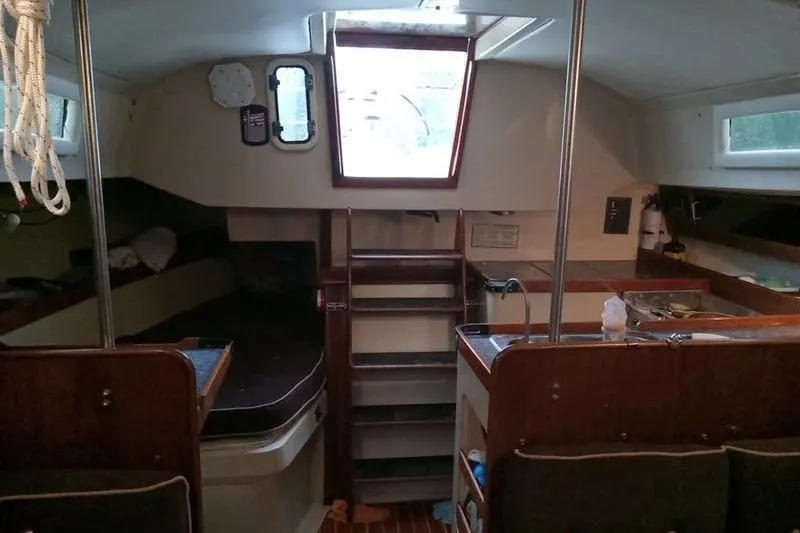 Slide: The Image of Interior of a 1979 C & C 36-1 sailboat with wooden cabinetry and seating. - 4
