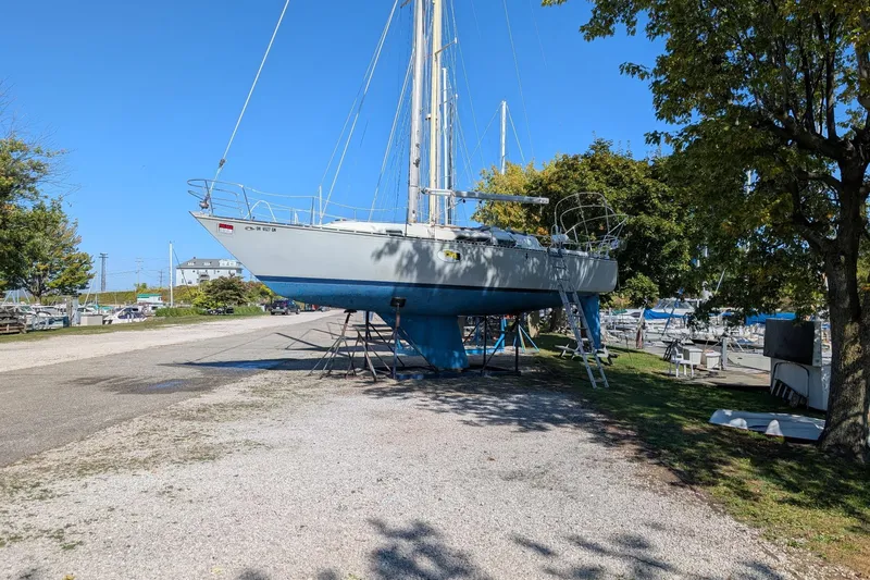 Slide: The Image of 1979 C & C 36-1 sailboat on stands in a marina, surrounded by trees. - 5