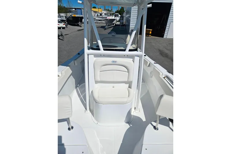 Slide: The Image of 2023 Sea Hunt Ultra 229 boat interior with white seating and console. - 14