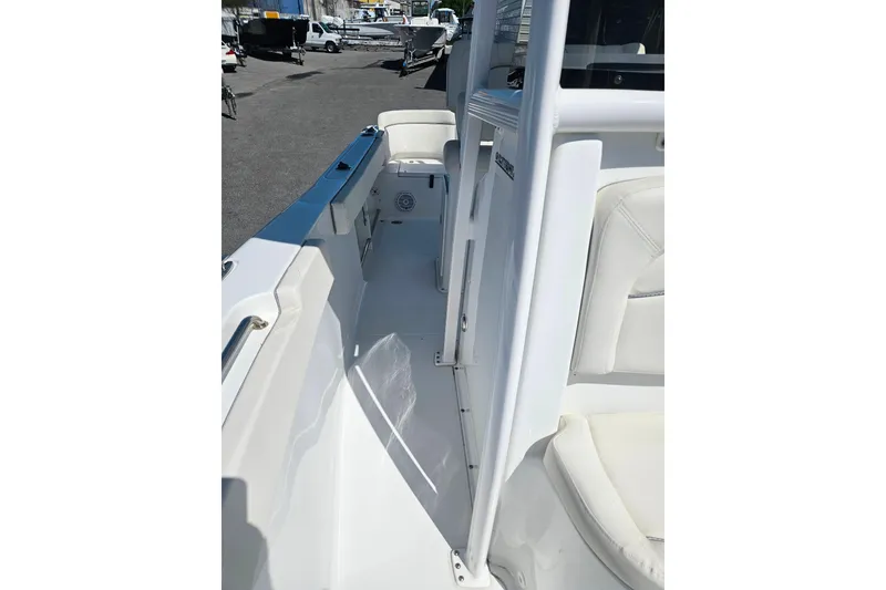Slide: The Image of 2023 Sea Hunt Ultra 229 boat interior with white seating and sleek design. - 15