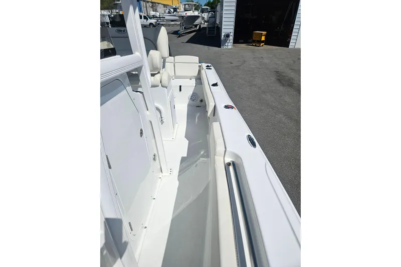 Slide: The Image of 2023 Sea Hunt Ultra 229 boat interior, showcasing sleek white design and seating arrangement. - 16
