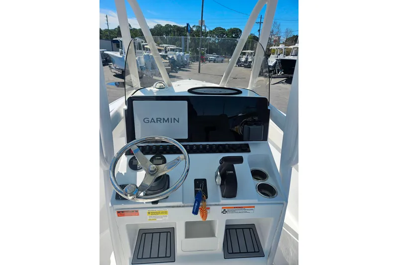 Slide: The Image of 2023 Sea Hunt Ultra 229 boat console with Garmin navigation system and steering wheel. - 21