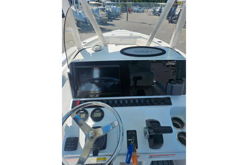 Slide: The Image of 2023 Sea Hunt Ultra 229 boat dashboard with steering wheel and controls. - 22