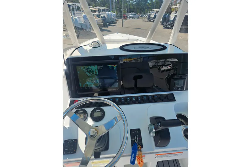 Slide: The Image of 2023 Sea Hunt Ultra 229 boat dashboard with navigation system and controls. - 23
