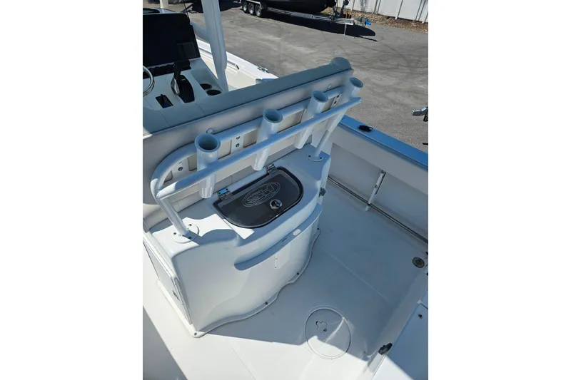 Slide: The Image of 2023 Sea Hunt Ultra 229 boat interior with rod holders and storage compartment. - 28