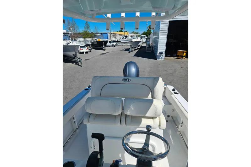 Slide: The Image of 2023 Sea Hunt Ultra 229 boat interior with steering wheel and seating. - 29