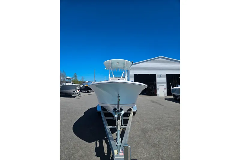 Slide: The Image of 2023 Sea Hunt Ultra 229 boat on trailer in front of a storage building. - 3