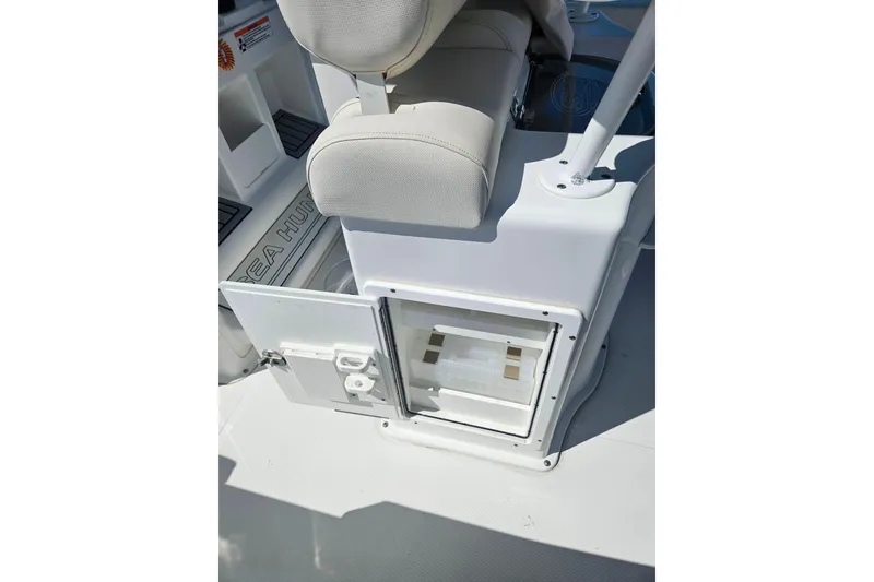 Slide: The Image of 2023 Sea Hunt Ultra 229 boat interior with storage compartment and seating. - 31