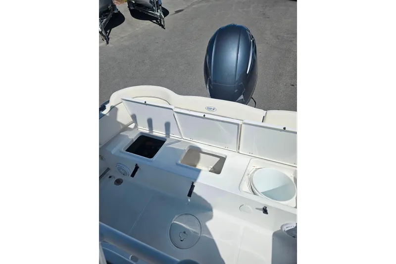 Slide: The Image of 2023 Sea Hunt Ultra 229 boat interior with storage compartments and engine view. - 8