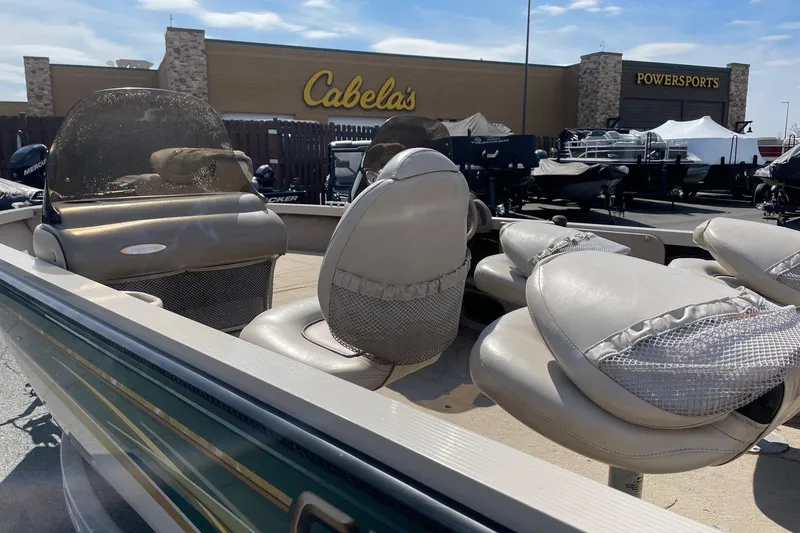 Slide: The Image of 2003 Crestliner 1850 Fish Hawk SC boat with seating, displayed outside Cabela's Powersports. - 5