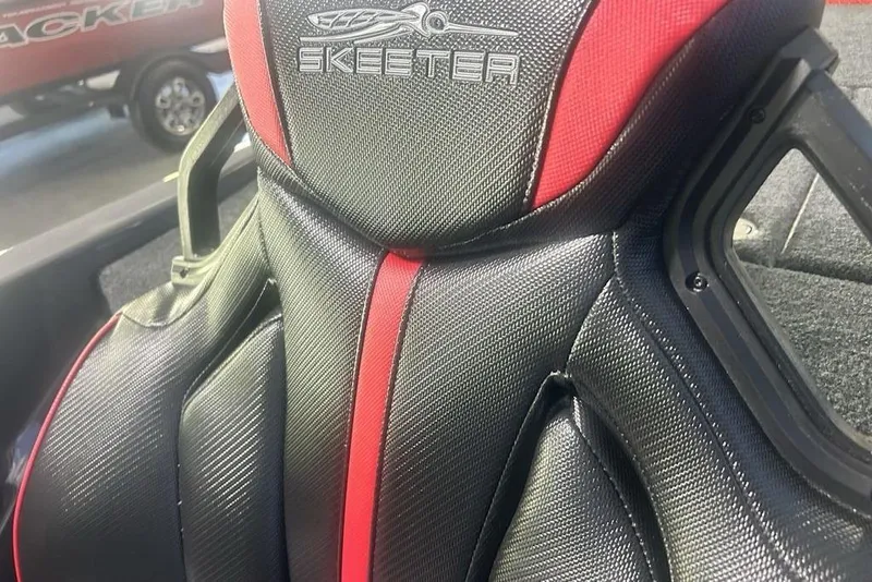 Slide: The Image of 2026 Skeeter ZXE20 boat seat with red and black design. - 12