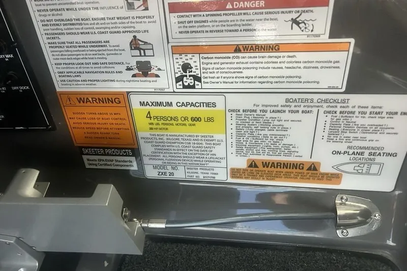 Slide: The Image of Safety and capacity labels on a 2026 Skeeter ZXE20 boat, detailing warnings and maximum load. - 15