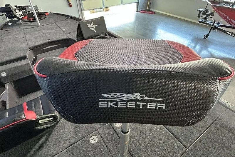 Slide: The Image of Skeeter ZXE20 boat seat, 2026 model, featuring black and red design in a garage setting. - 17