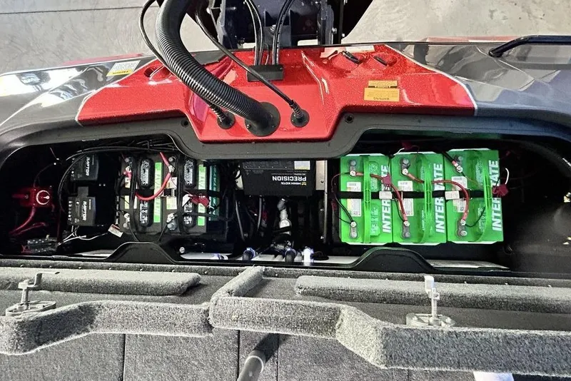 Slide: The Image of Battery compartment of 2026 Skeeter ZXE20 boat, featuring Interstate batteries and wiring. - 18