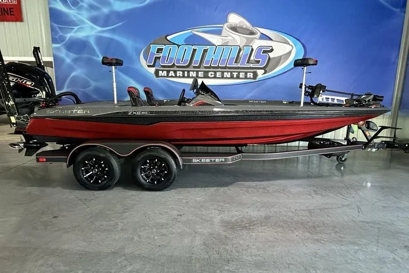 The Image of 2026 Skeeter ZXE20 boat in showroom, red and black design, on trailer at Foothills Marine Center. - 2