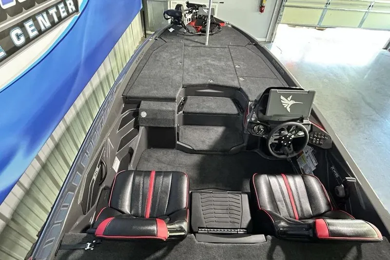 Slide: The Image of 2026 Skeeter ZXE20 boat interior with black and red seats, steering console, and carpeted deck. - 20