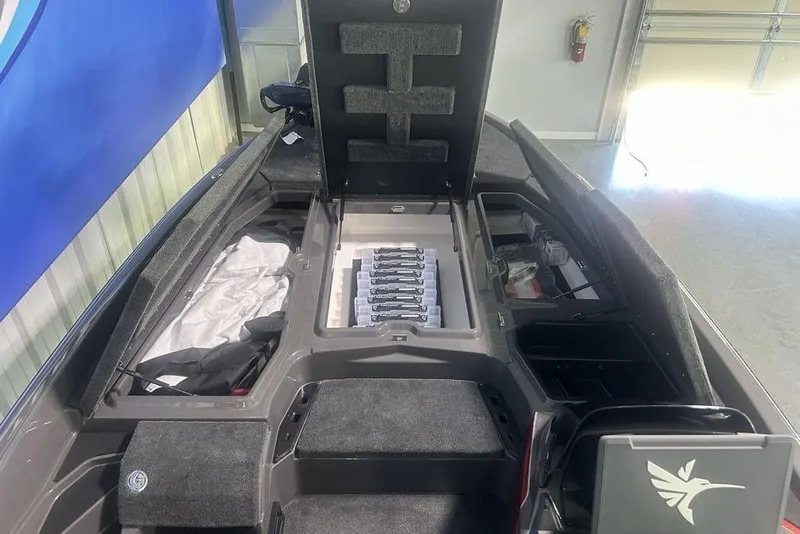 Slide: The Image of 2026 Skeeter ZXE20 boat interior with open storage compartments and organized gear. - 9