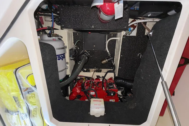 Slide: The Image of Engine compartment of a 2023 Regal 26 XO boat, featuring safety equipment and mechanical components. - 100