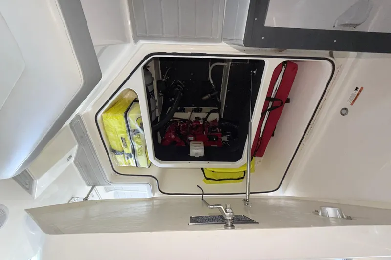 Slide: The Image of 2023 Regal 26 XO boat interior storage compartment with safety equipment. - 101