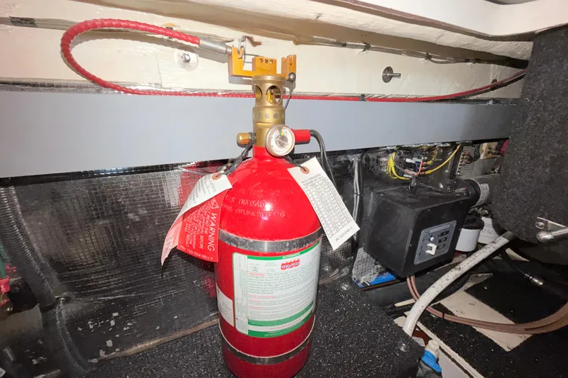 Slide: The Image of Fire extinguisher in 2023 Regal 26 XO boat engine compartment. - 105