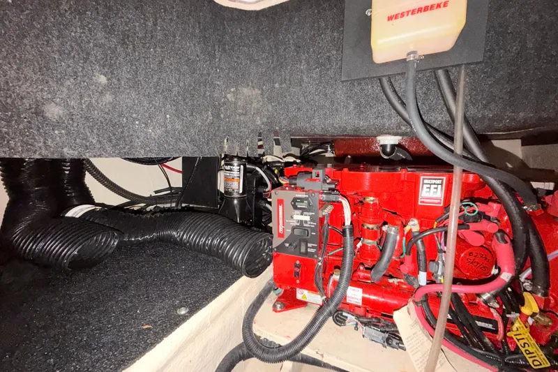 Slide: The Image of Engine compartment of 2023 Regal 26 XO boat with red EFI engine components. - 107