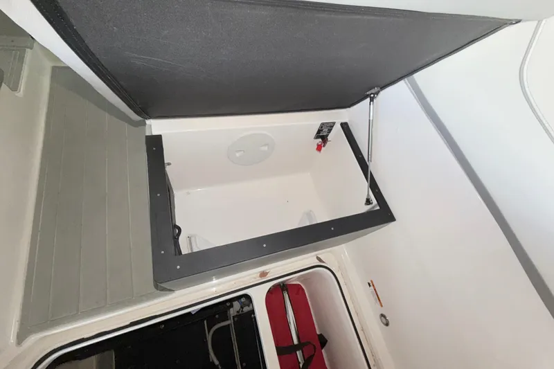 Slide: The Image of 2023 Regal 26 XO boat interior storage compartment with open hatch. - 109