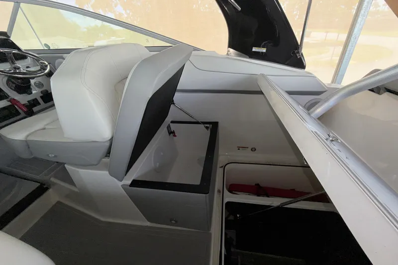 Slide: The Image of 2023 Regal 26 XO boat interior with open storage compartments and white seating. - 110