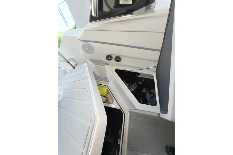 Slide: The Image of 2023 Regal 26 XO boat interior storage compartments with open hatches. - 114
