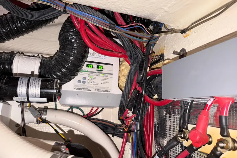 Slide: The Image of Electrical wiring and components inside a 2023 Regal 26 XO boat. - 116
