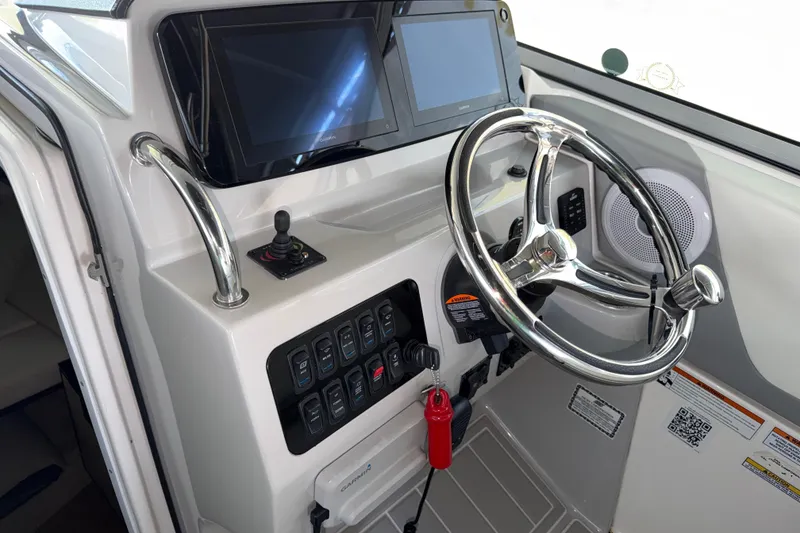 Slide: The Image of 2023 Regal 26 XO boat helm with modern controls and dual displays. - 119