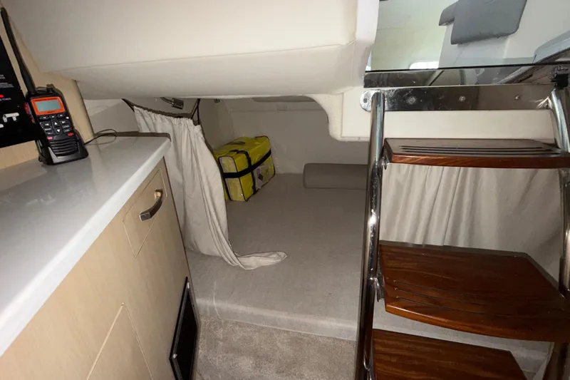 Slide: The Image of Interior cabin of 2023 Regal 26 XO boat with wooden steps and storage area. - 121