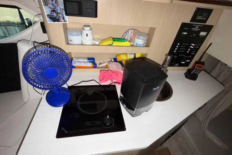 Slide: The Image of Interior of 2023 Regal 26 XO boat with fan, stove, and control panel. - 125