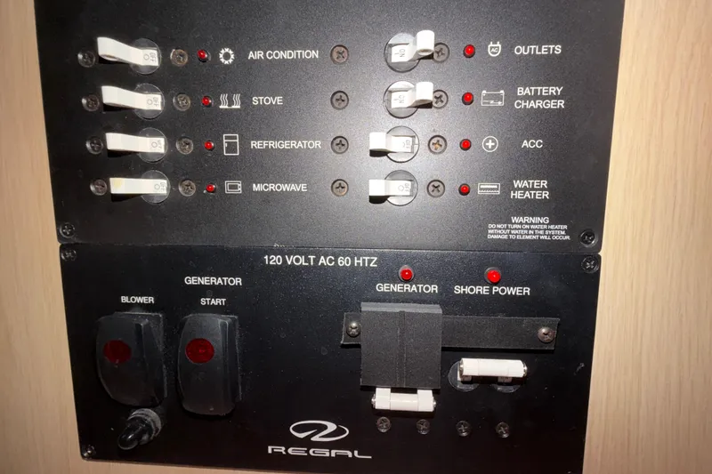 Slide: The Image of Control panel of a 2023 Regal 26 XO boat with switches and indicators. - 127